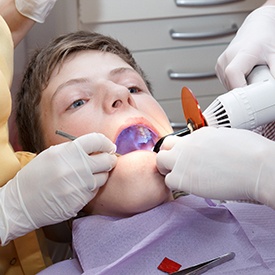 A younger patient receiving dental fillings.