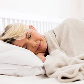 Woman sleeping peacefully in her bed