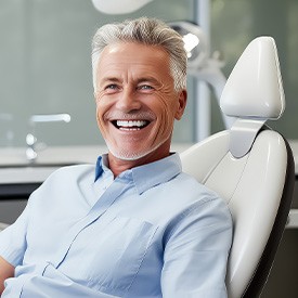 Smiling man sitting in dentist's treatment chair